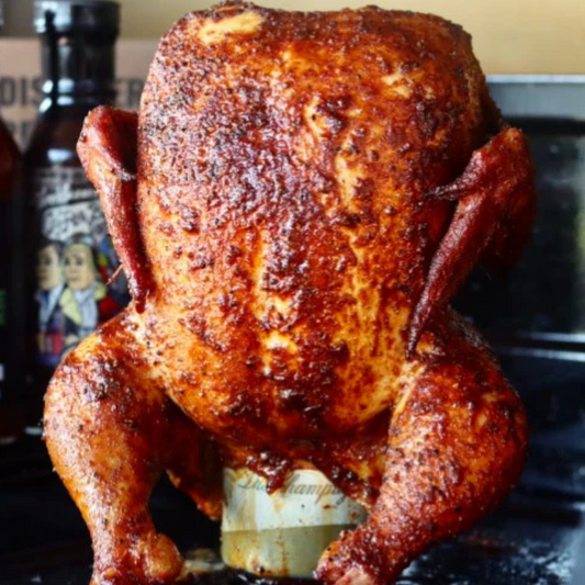 Close-up of beer-can chicken with crisp golden skin glazed with tropical sauce