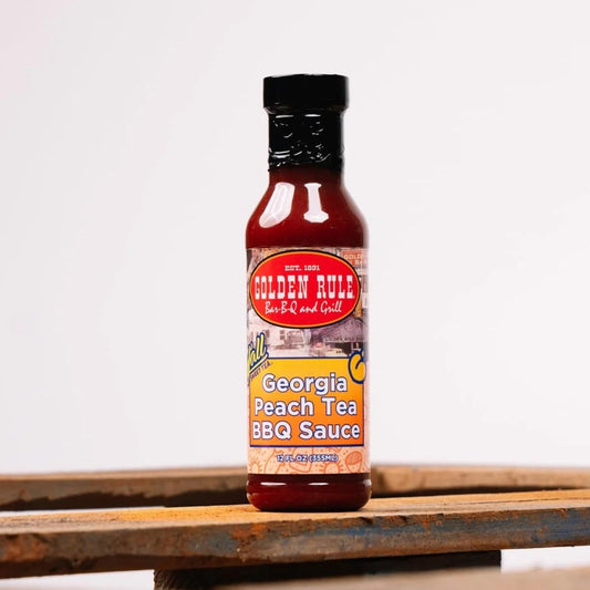 Golden Rule Georgia Peach Sweet Tea BBQ Sauce bottle on a wooden table