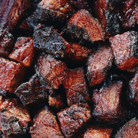 Close-up of caramelized beef burnt ends with glaze from blueberry chipotle bourbon sauce