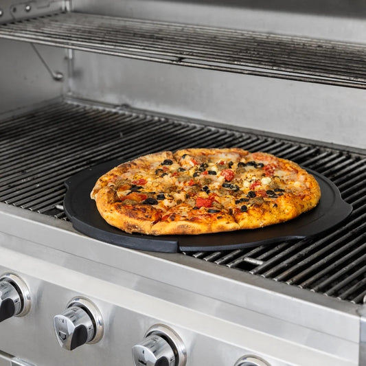 Pizza baking on the Outset 18 inch cast iron pizza pan on a gas grill