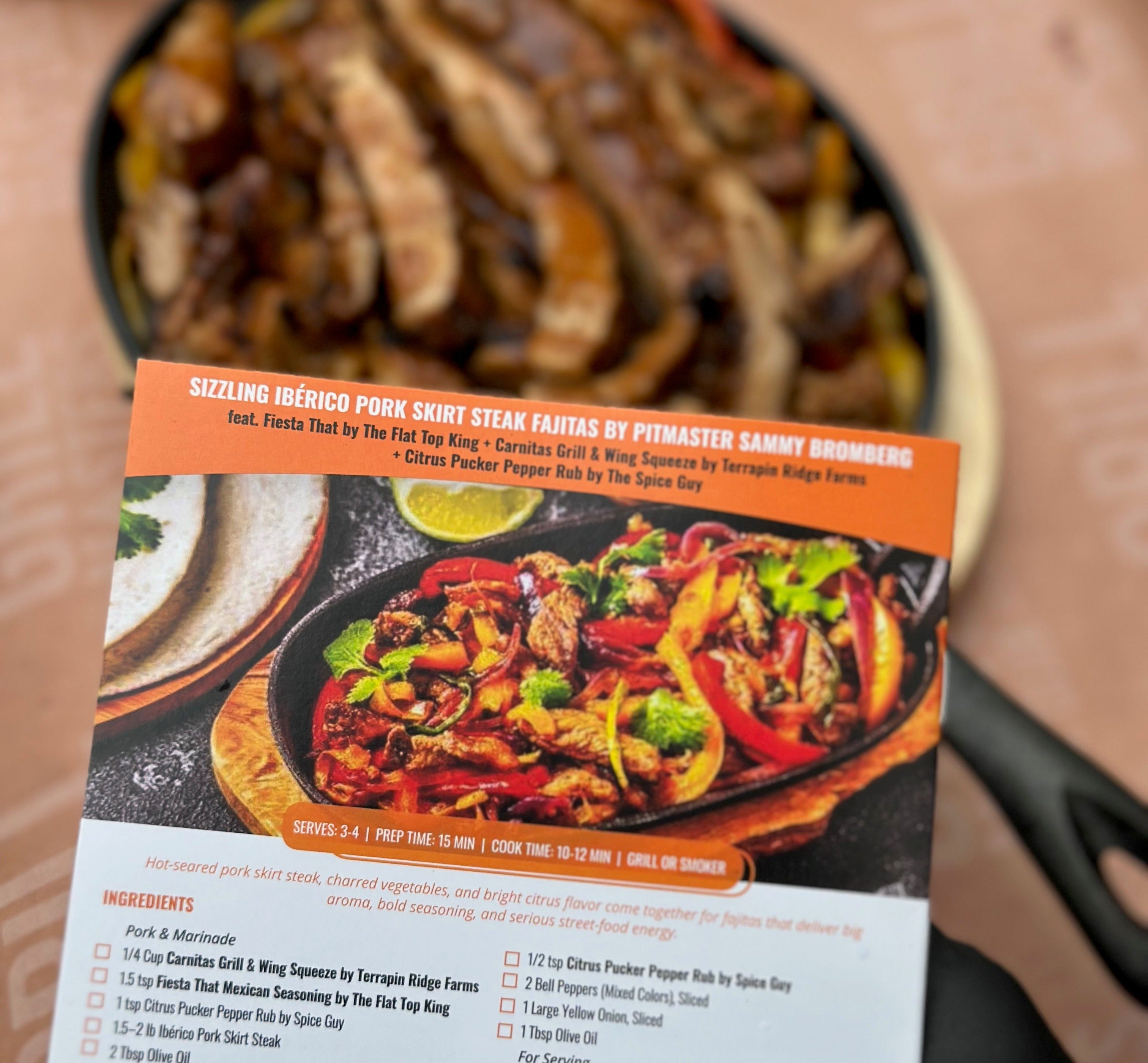 Menu card for Sizzling Ibérico Pork Skirt Steak Fajitas with ingredients list on a wooden surface.